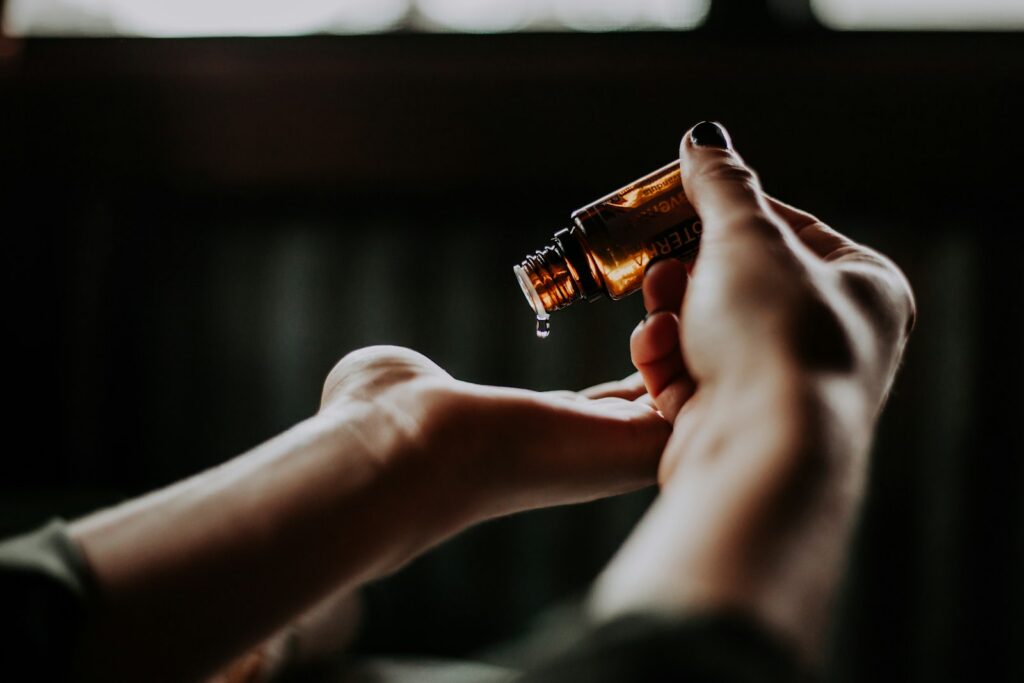 Amber glass bottle with resin oil droplet, representing amber and resins in fragrance