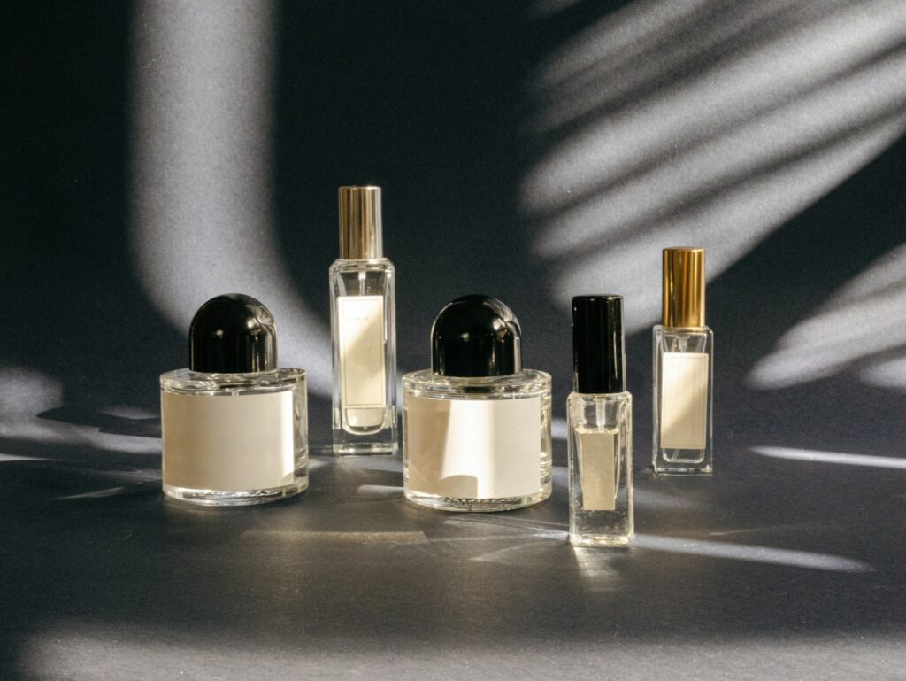A group of different perfume bottles arranged together, representing the process of choosing a fragrance