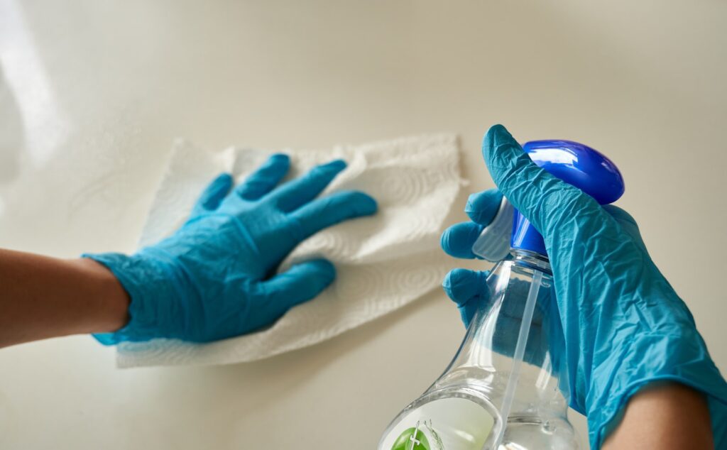 Wiping a perfume bottle clean with a soft cloth